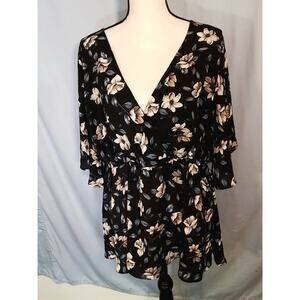 Torrid print top. tan flowers, blue leaves on black background.